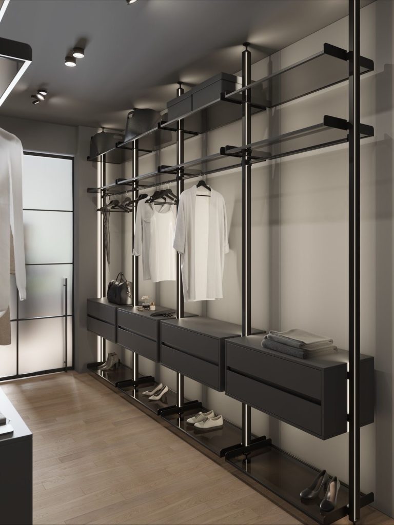 Open wardrobe with black metal rails and wood flooring